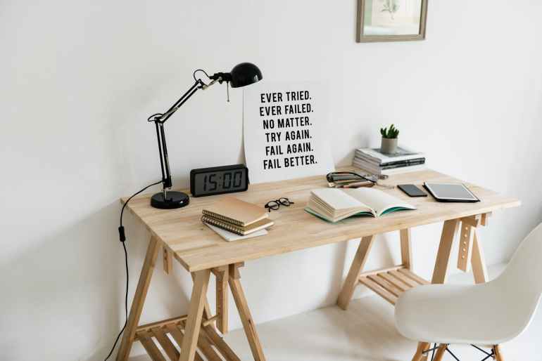 wooden desk with books on top